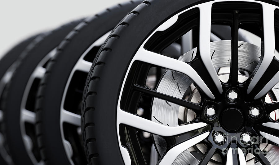 Set of wheels with modern alu rims close-up on white Photograph by Michal Bednarek