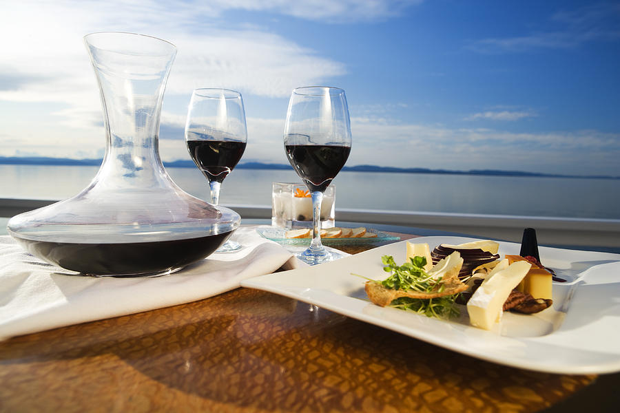 Set table with gourmet appetizer and two glasses on red wine Photograph by Twohumans