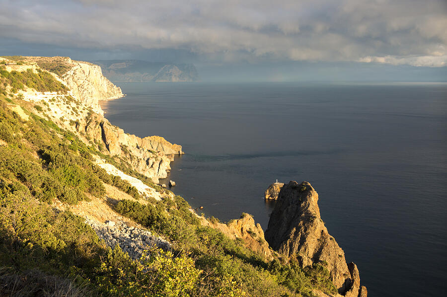 Setting sun over sea coast, Crimea Photograph by Vyacheslav Argenberg