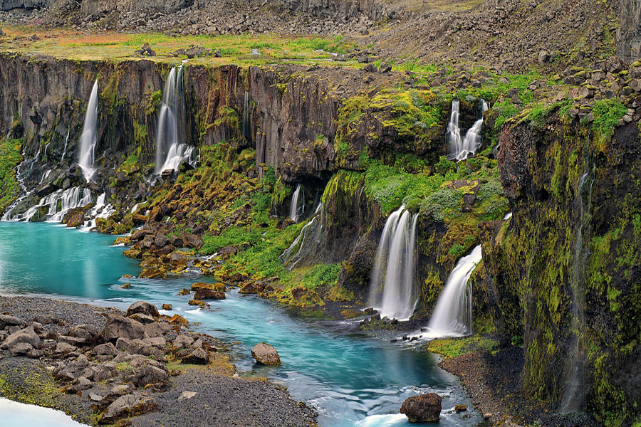 Several waterfalls flowing into a river in a canyon in a remote area Photograph by Rainer Grosskopf