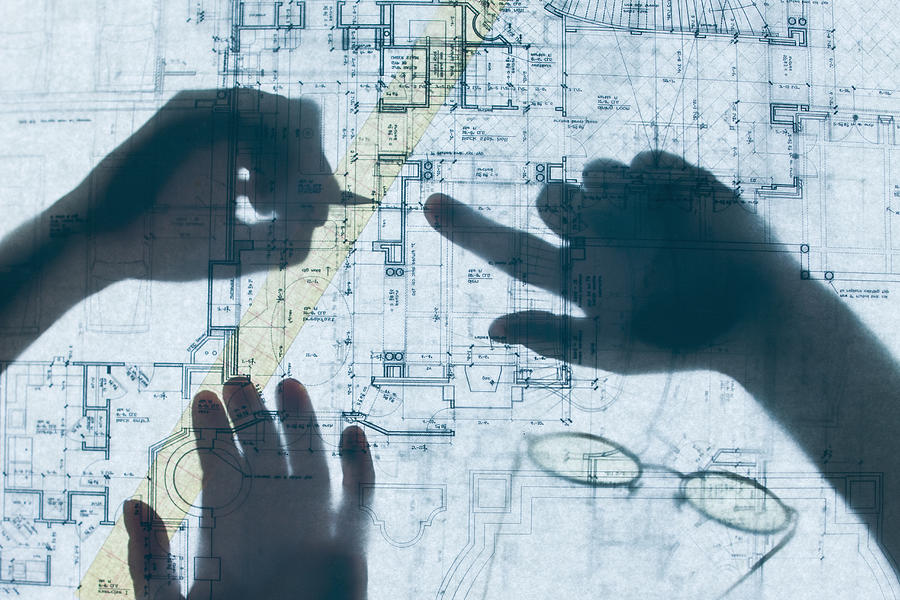 Shadow of hands on blueprints Photograph by Terry Vine