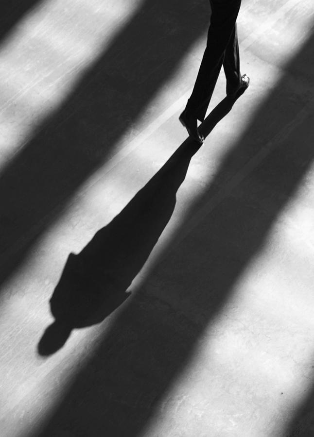 Shadow of man walking. Photograph by Grant Faint