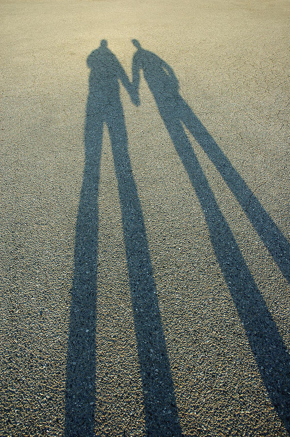 Shadow of two people holding hands Photograph by Anthony Boccaccio