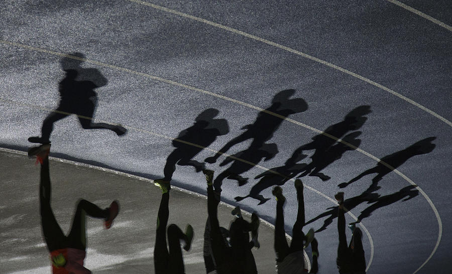 Shadows of a group of runners Photograph by David Trood
