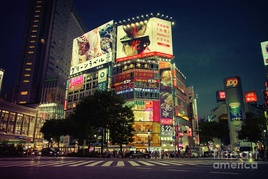 Shibuya Crossing at night, with traffic, pedestrians and the city shops and nightlife. Retro tones. Photograph by Jane Rix