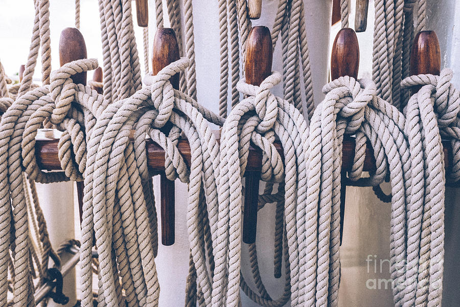 Ship ropes tied to the mast before lowering sails. Photograph by Joaquin Corbalan