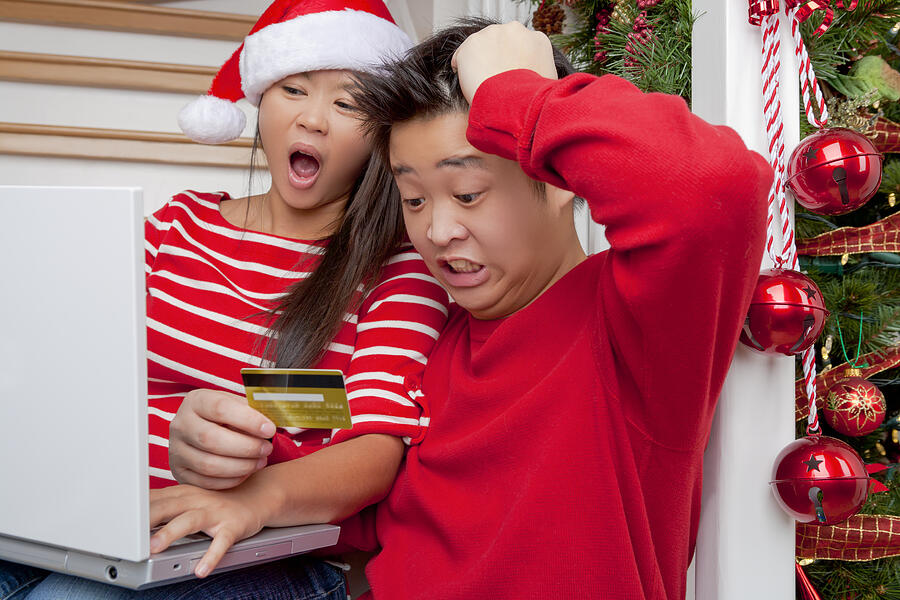 Shocked asian couple christmas online shopping Photograph by ChristopherBernard