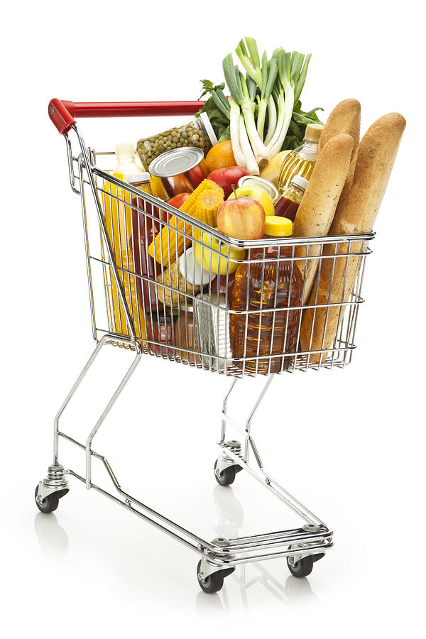 Shopping cart filled with variety of groceries on white backdrop Photograph by Fcafotodigital