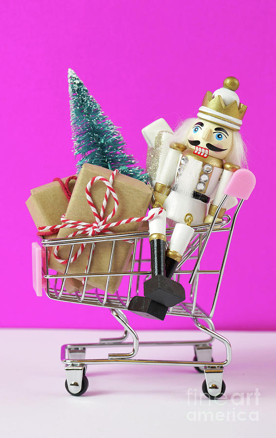 Shopping cart full of Christmas gifts, tree and nutcracker ornament. Photograph by Milleflore Images