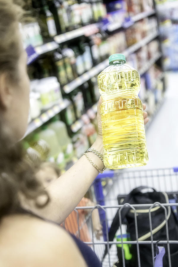 Shopping for cooking oil Photograph by Juanmonino