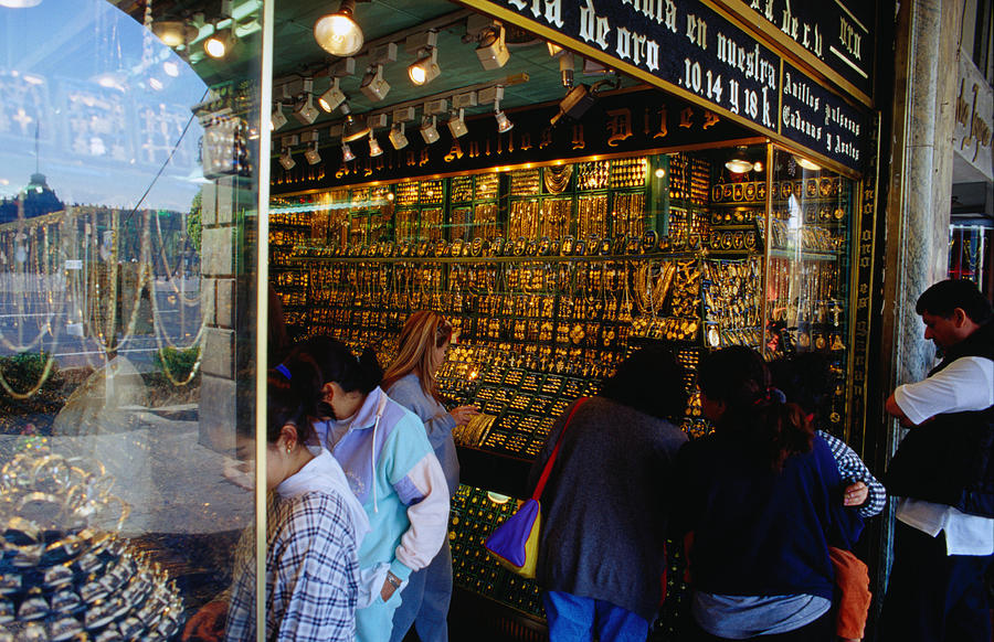Shopping for gold on the Zocalo, Mexico Citys huge square, the Zocalo is dominated on the west side by shop after shop of gold and silver jewellery Photograph by Richard IAnson