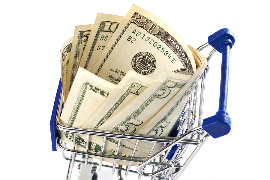 Shopping trolley with money isolated Photograph by Sergeyryzhov
