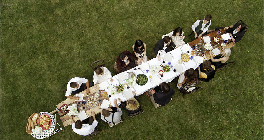 Shot above looking down Friends at outdoor dinner Photograph by Nisian Hughes