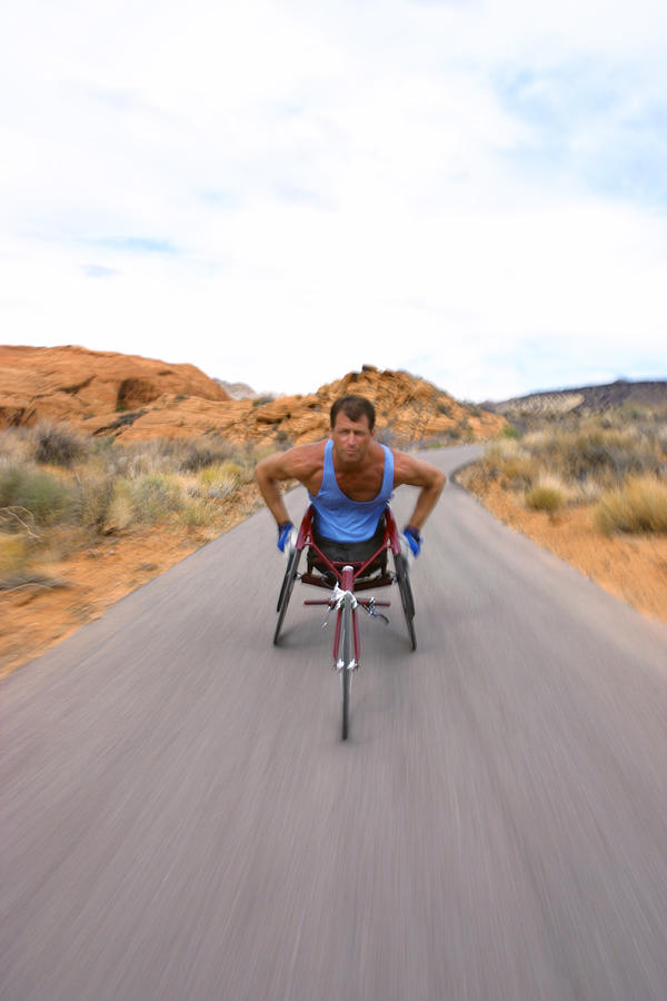 Shot Of A Male Caucasian Wheelchair Racer As He Trains In A Rural Red Rock Setting Photograph by Photodisc