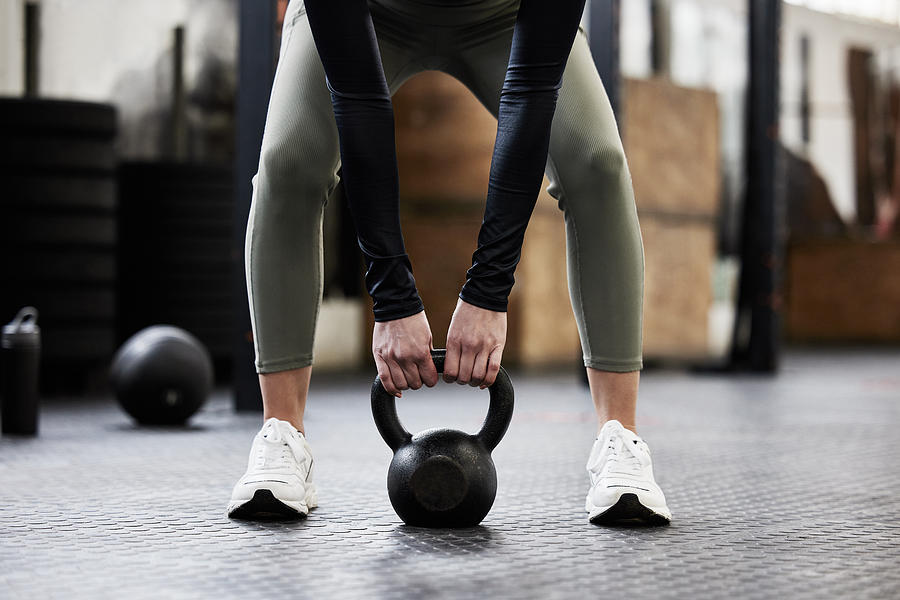 Shot of a woman working out with a kettle bell Photograph by PeopleImages