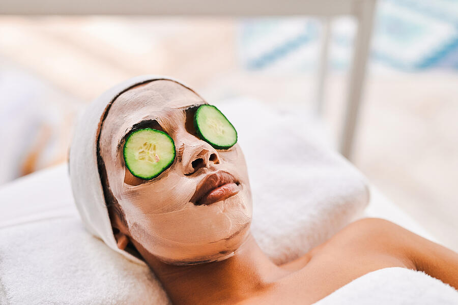 Shot of an attractive young woman getting a facial at a beauty spa Photograph by Moyo Studio