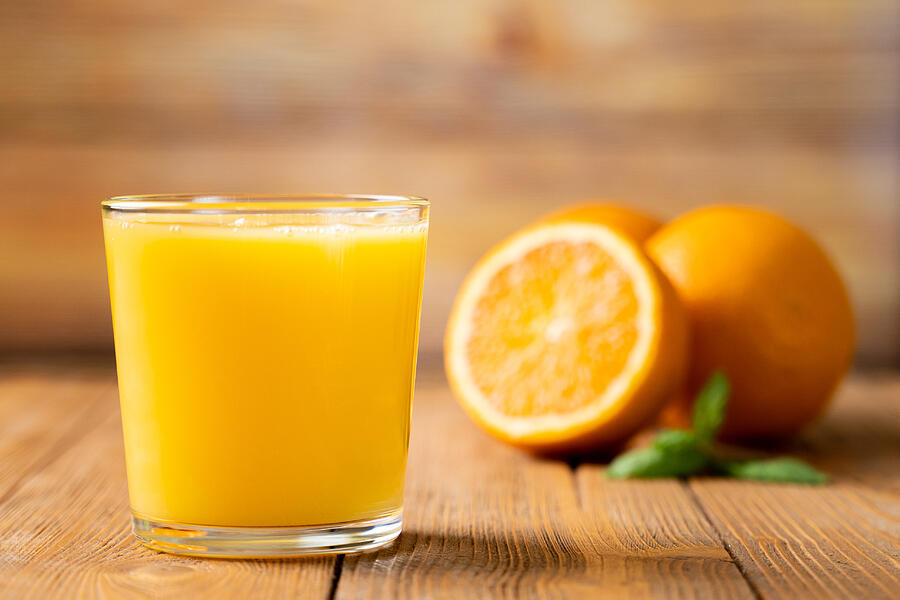 Shot of Fresh Orange Juice in a Glass Photograph by Viktoria Korobova