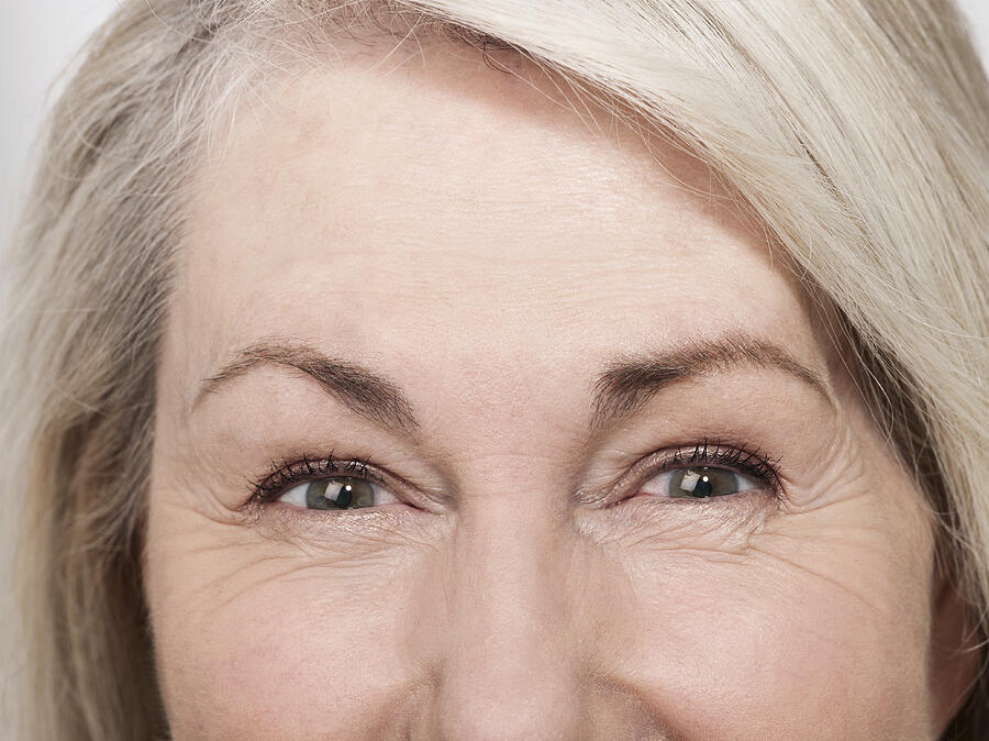 Shot of mature womans green eyes Photograph by Jonathan Storey