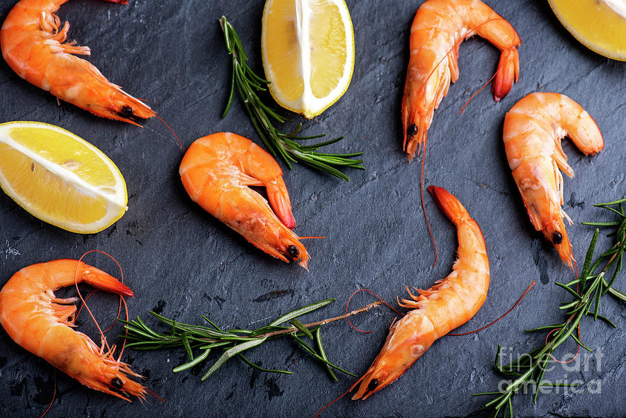 Shrimps With Lemon And Rosemary On Black Background Photograph