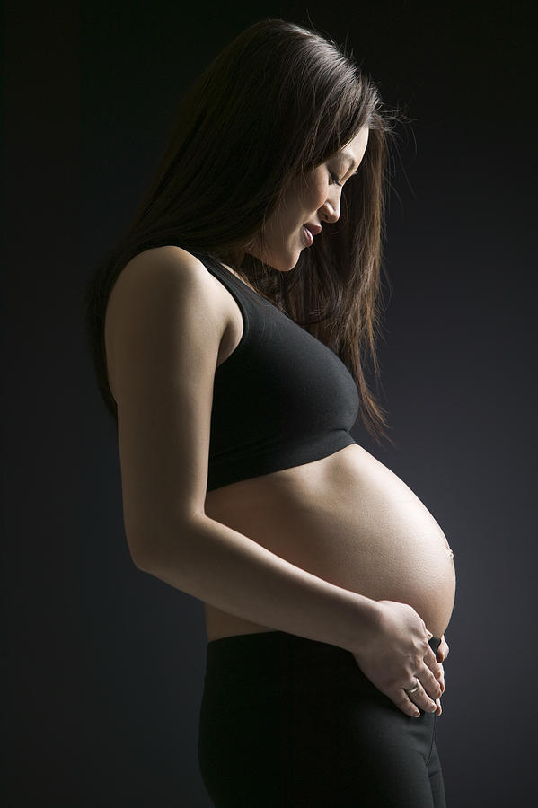 Side profile of a young pregnant woman Photograph by Photodisc