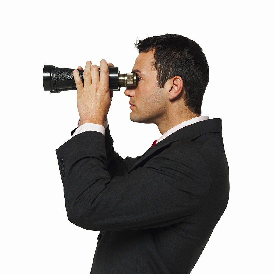 Side View Of A Businessman Looking Through Binoculars Photograph by George Doyle