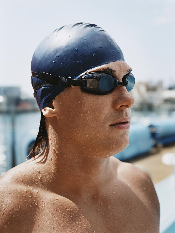 Side View of a Young Man Wearing Swimming Goggles and Cap Photograph by Digital Vision.