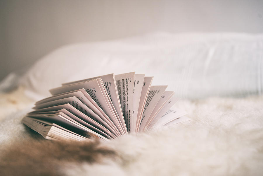 Side view of an open book lying on a bed Photograph by Emilija Manevska