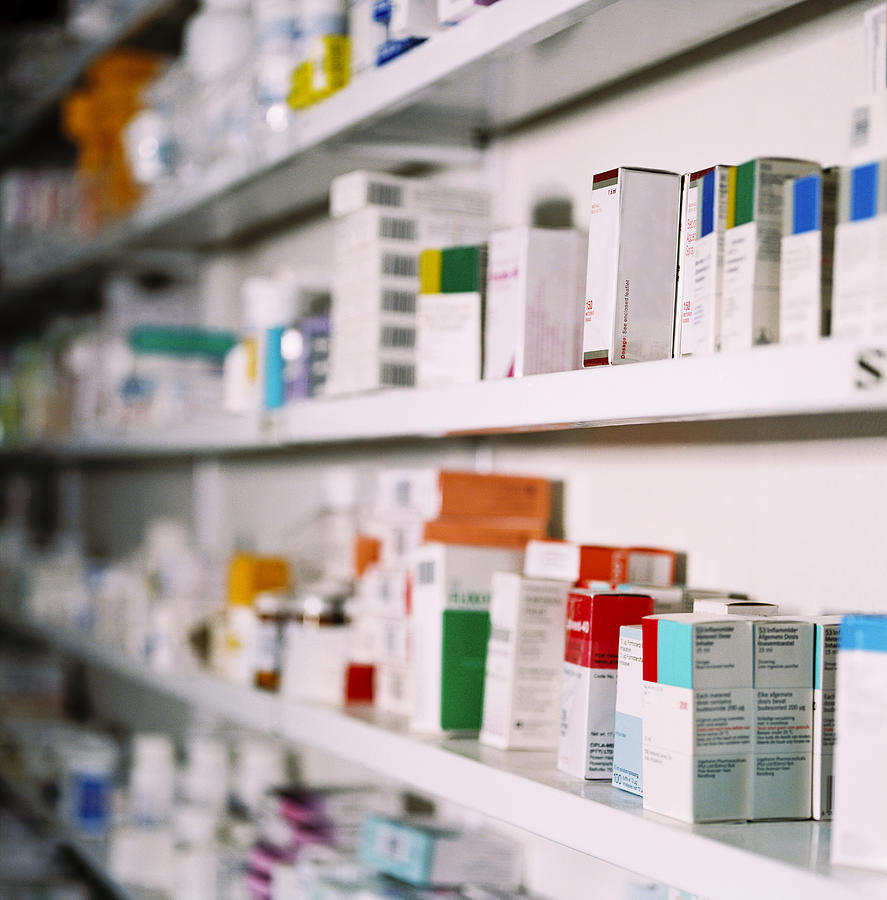 Side View Of Rows Of Medicines On A Shelf Photograph by George Doyle