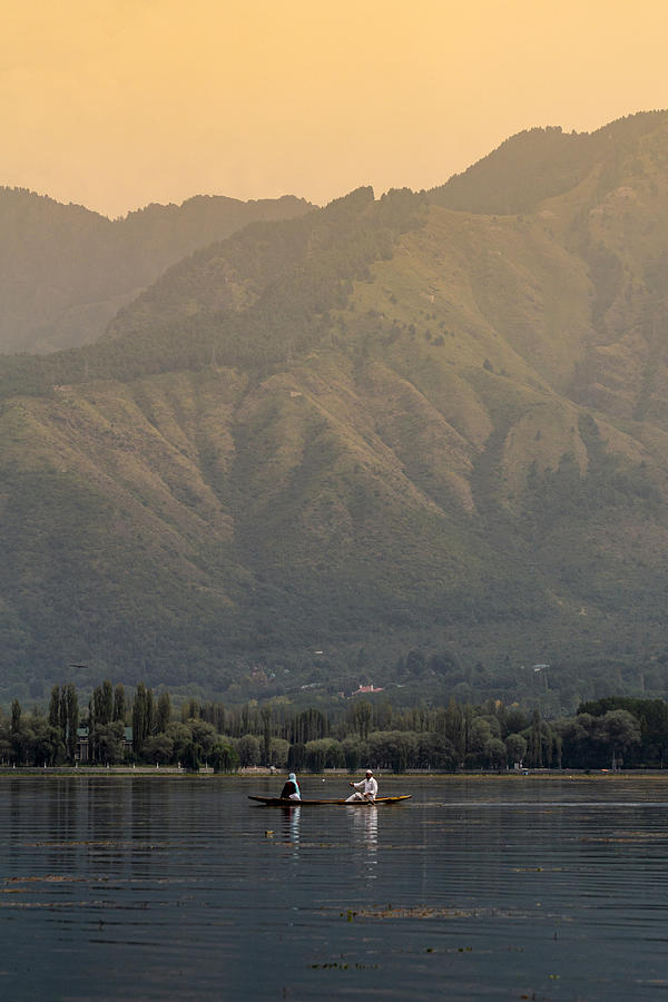 Sightseeing over Dal Lake using a shikara - a type of wooden boat. Shikara are of varied sizes and are used for multiple purposes, including transportation of people. Photograph by Shaifulzamri