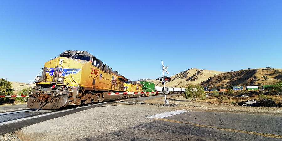Sign of the Times -- Union Pacific Freight Train at a Railroad Crossing in Caliente, California Photograph by Darin Volpe