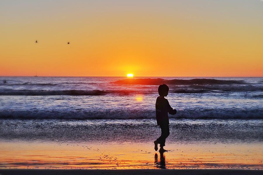 Silhouette Boy Walking At Beach Against Sky During Sunset Photograph by Jesse Coleman / EyeEm Silhouette Boy Walking At Beach Against Sky During Sunset Photograph by Jesse Coleman / EyeEm