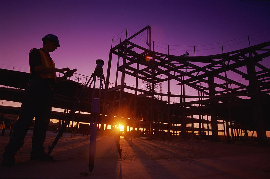 Silhouette of a Builder Working on a Building Site Photograph by Digital Vision.