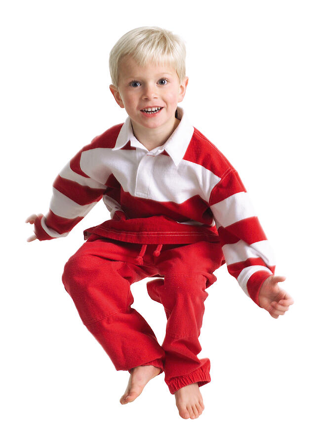 Silhouette Of A Caucasian Blonde Male Child In Red Pants And A Stripped Shirt As He Hops Up In The Air Photograph by Photodisc