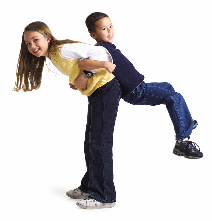 Silhouette Of A Caucasian Female Child Lifts Up Her Little Brother On Her Back As They Both Smile Photograph by Photodisc