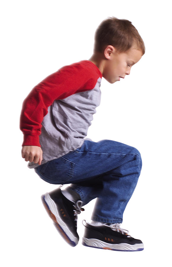 Silhouette Of A Caucasian Male Child In Jeans And A Red Shirt As He Jumps Sideways Through The Air Photograph by Photodisc