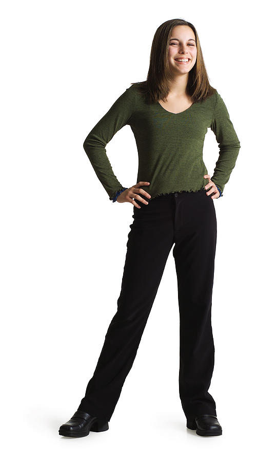 Silhouette Of A Caucasian Teenage Girl In Black Pants And A Green Shirt As She Smiles At The Camera Photograph by Photodisc