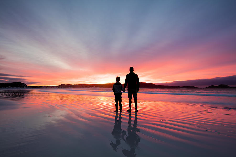 Silhouette of a father and son holding hands on beach at sunset, Western Australia, Australia Photograph by Seanscott