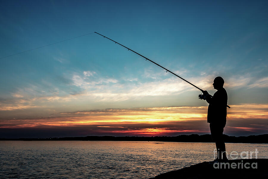 Silhouette Of A Fisherman With His Pole At The Atlantic Coast Of Wales, United Kingdom Photograph by Andreas Berthold