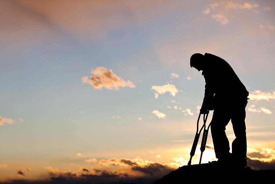 Silhouette of a Sad Injured Man With Crutches Photograph by ImagineGolf