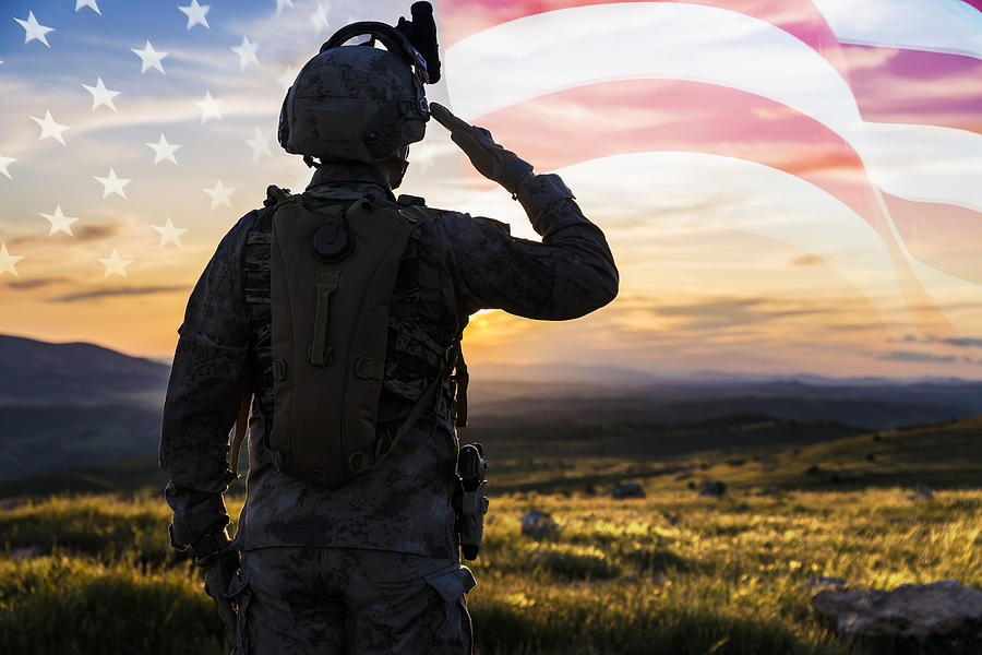 Silhouette Of A Solider Saluting Against US Flag at Sunrise Photograph by Guvendemir