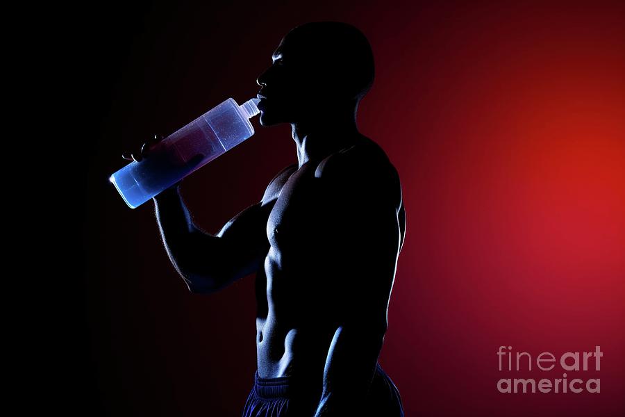 Silhouette Of An Athlete Man Hydrating After Exercising, Backlit In Studio. Photograph