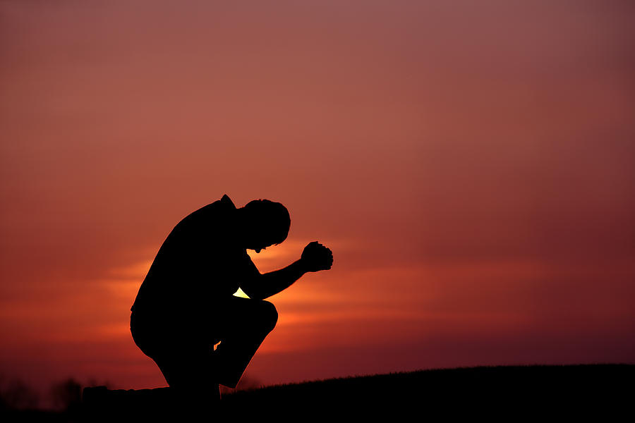 Silhouette of Man Praying at Dusk Photograph by ImagineGolf