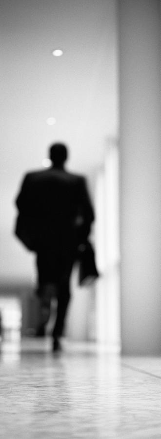 Silhouette of man walking in a hallway, blurred, B&W Photograph by Teo Lannie