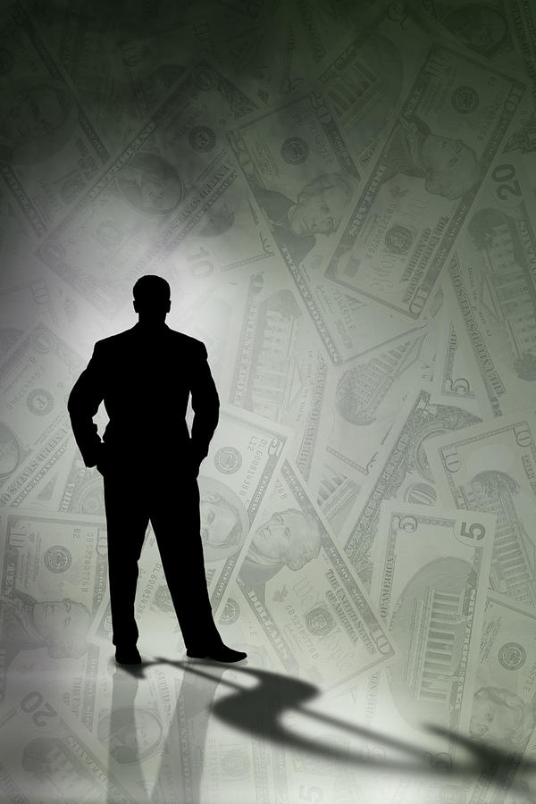 Silhouette of man with money Photograph by Comstock Images
