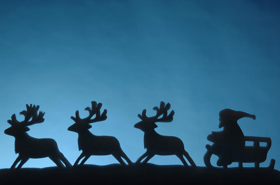 Silhouette of Santa with his reindeers Photograph by Simon Katzer