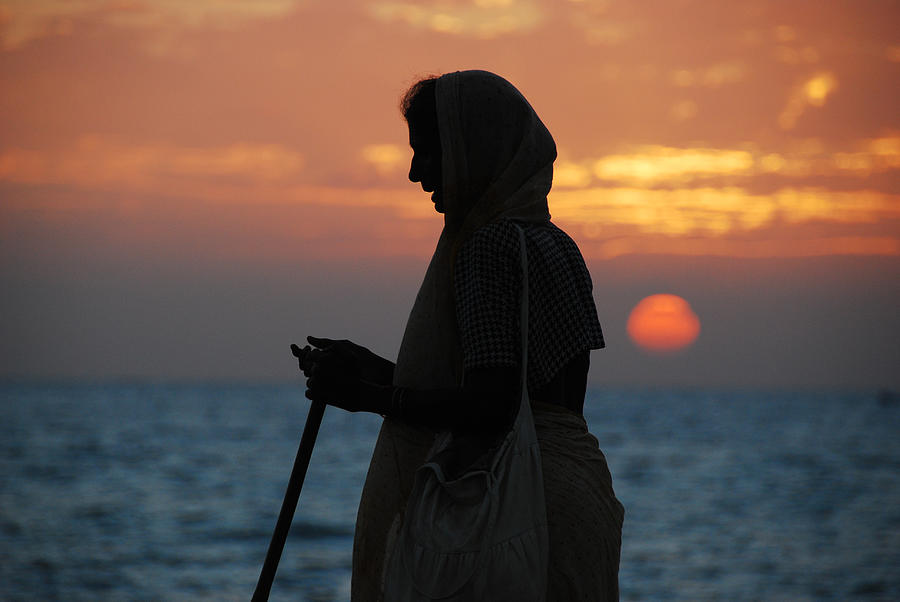 Silhouette of the old Indian woman against the sun Photograph by Alex Grabchilev / Evgeniya Bakanova