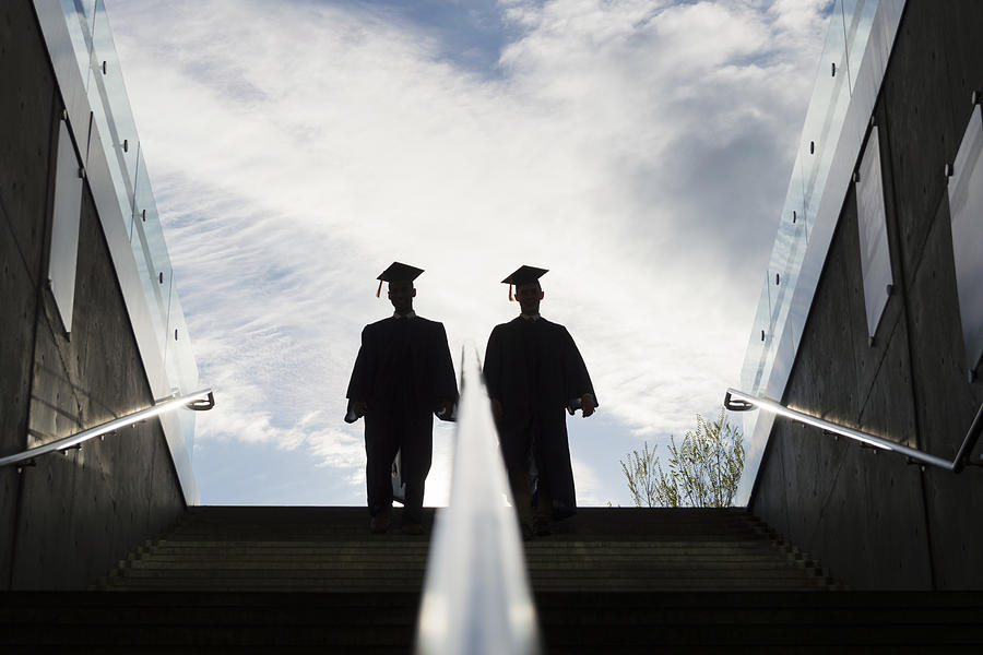 Silhouette of Two College Graduates Climbing Steps Photograph by Aaron Hawkins