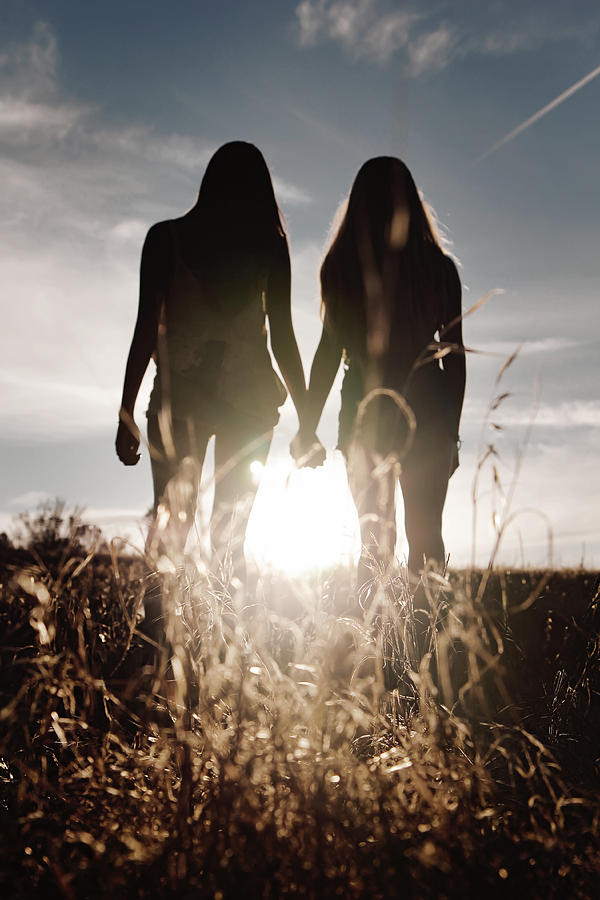 Silhouette of two teenage girls holding hands Photograph by Dianne Avery Photography