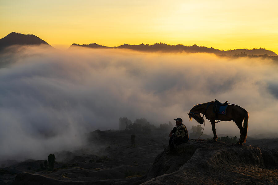 Silhouette of unidentified local people or Bromo Horseman at the mountainside of Mount Bromo, Semeru, Tengger National Park, Indonesia. Photograph by Shaifulzamri