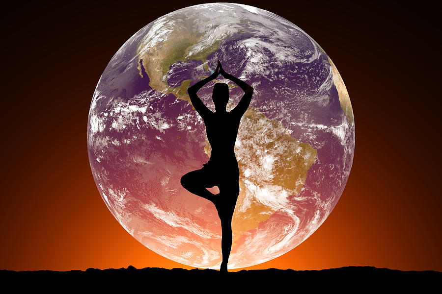 Silhouette of women doing yoga on the background of the planet Earth. Photograph by Anton Petrus